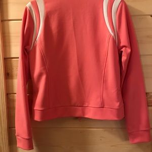 Thalia Sodi salmon color active wear jacket.